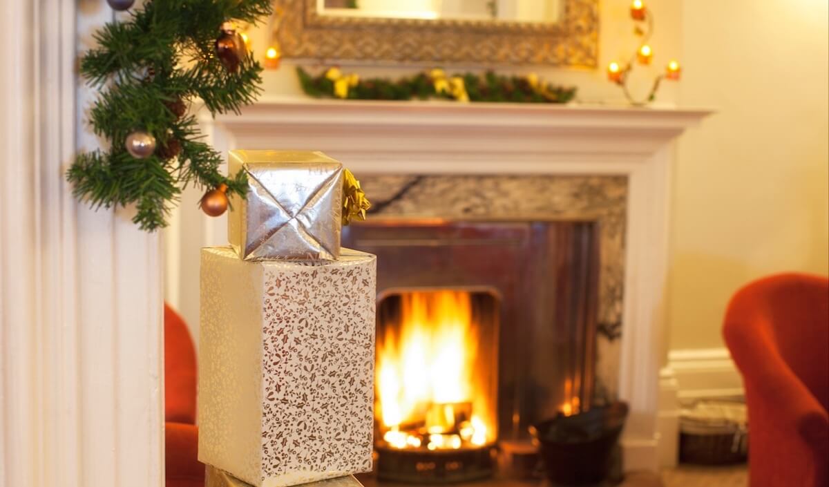 Christmas Break - A crackling log fire and Christmas decorations in the lounge at Luccombe Hall