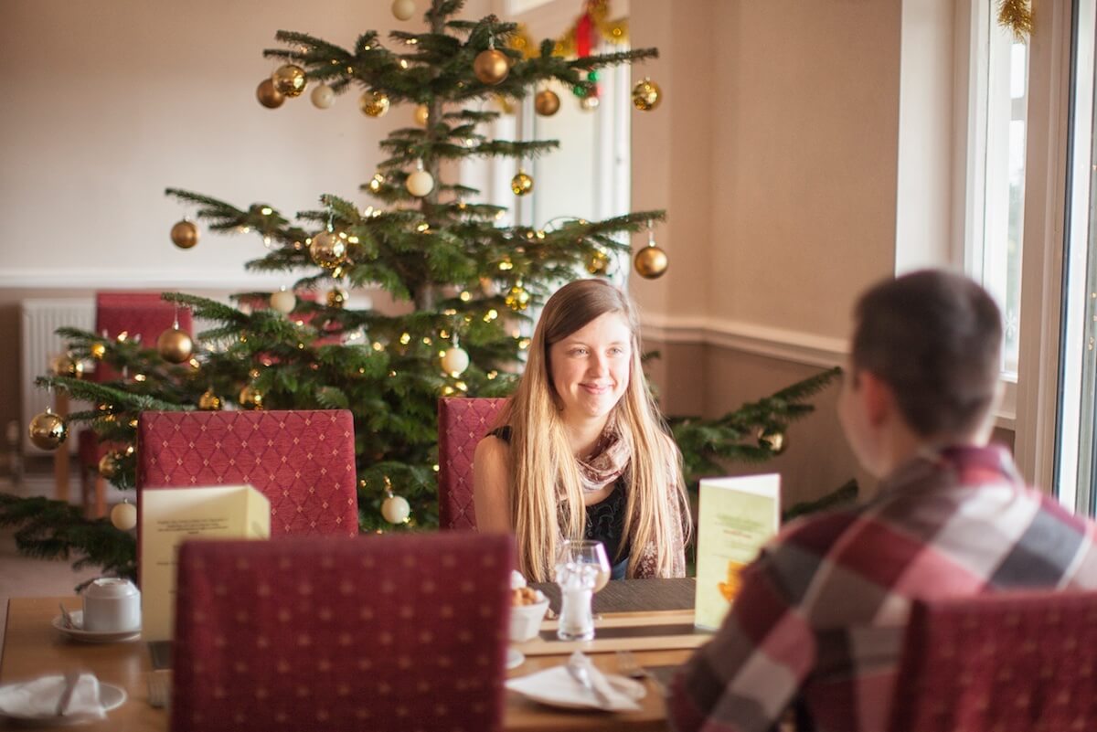 Christmas Break - Guests enjoying the Christmas tree and decorations at Luccombe Hall