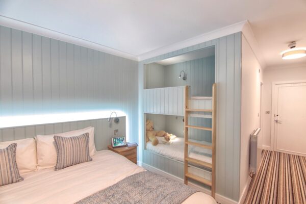 A family room with built-in bunk beds