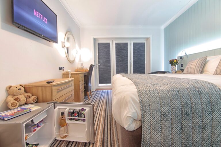 Rooms - A family room with a double bed, sofa and bunk beds