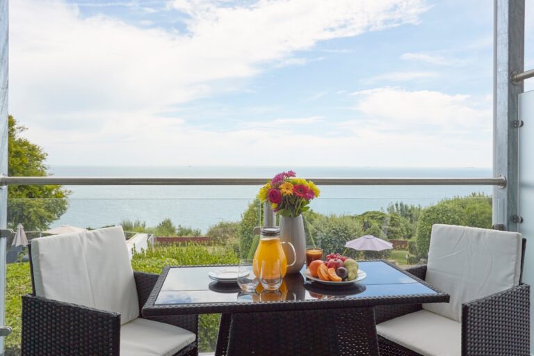 Rooms - The balcony table of a Sea-Facing Room overlooking the gardens and Sandown Bay