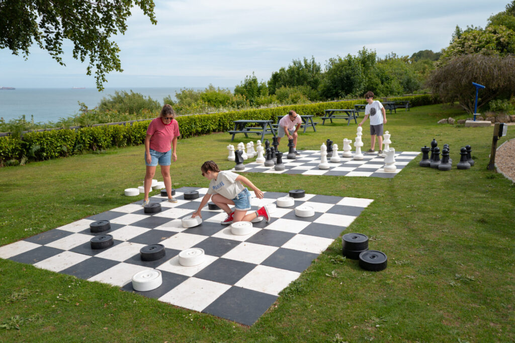 Giant chess and draughts on the lawn above the sea