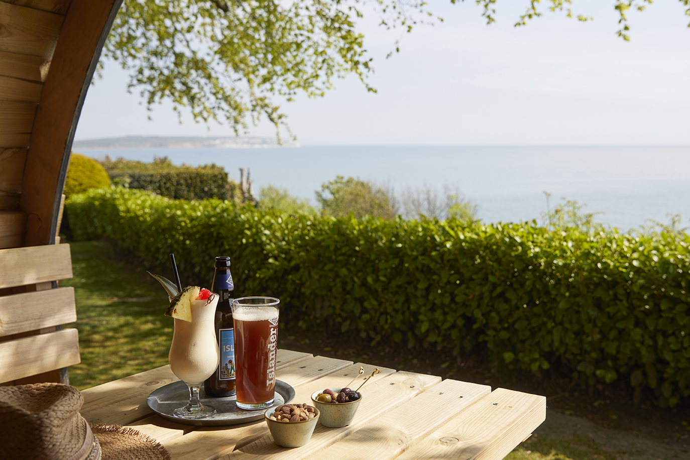 Cocktails in a garden pod looking out to sea